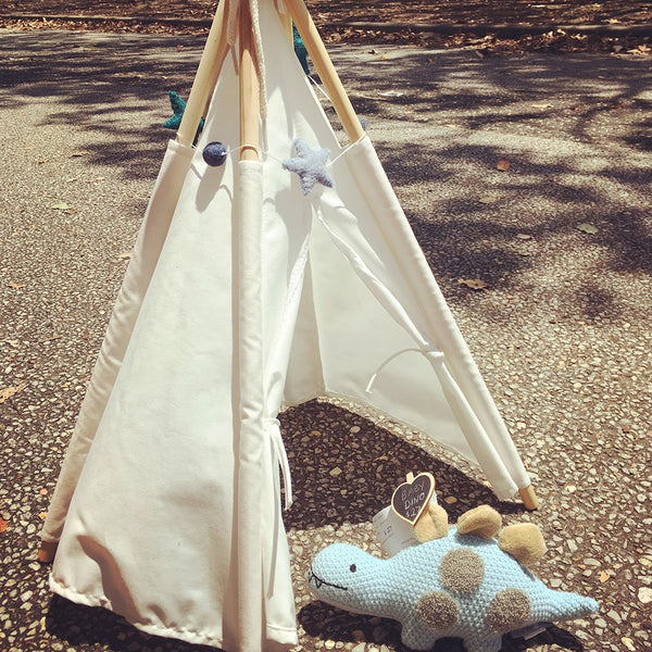baby dino hanging out inside a toy teepee